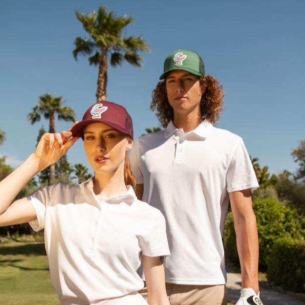 A guy and a girl with golfcaps with patches